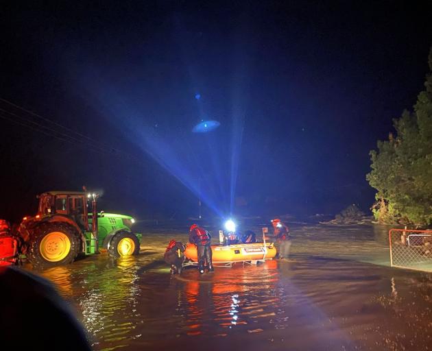 Rod May’s tractor lights up the Hawkins River. Photo: Supplied