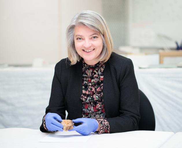 Dr Jill Haley holds a Spratt’s dog cake fragment from the Canterbury Museum collection. PHOTO:...