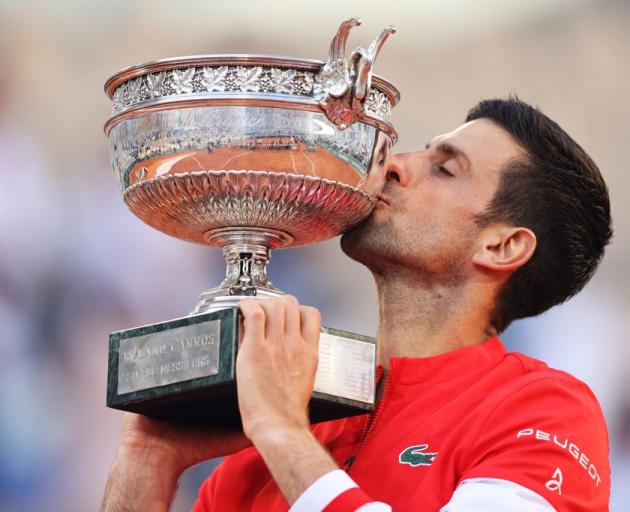 Novak Djokovic celebrates with the French Open trophy. Photo: Reuters
