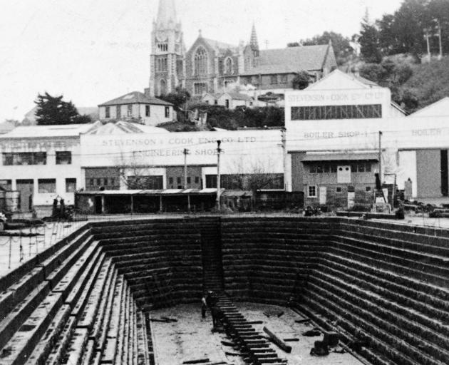 The empty Port Chalmers’ dock in 1914 with Stevenson and Cook’s multiple workshops in the...
