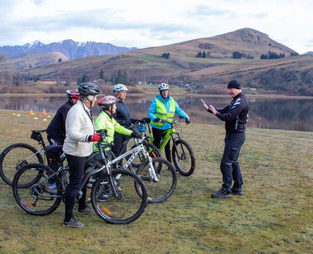 Instructor Chris Foggin teaches a group of riders on the Cycling Uncovered programme next to Lake...