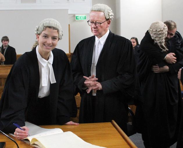 Retired lawyer Winston Forrest swears in his daughter Jennifer as a barrister and solicitor in...