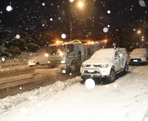 A Fulton Hogan truck ploughs snow in Taieri Rd this morning. Photo: Stephen Jaquiery