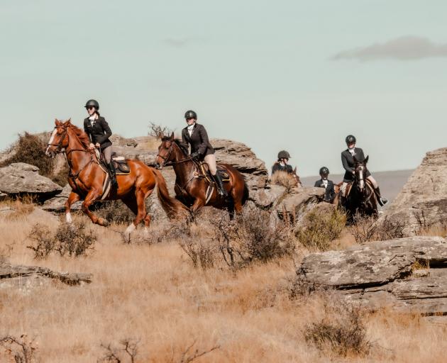 Leading a pack of riders through schist rock at an Otago Hunt Inc event in Middlemarch in April this year are Tori Brown (left) and Annabelle Dean. Photo: Kerri Back Photography