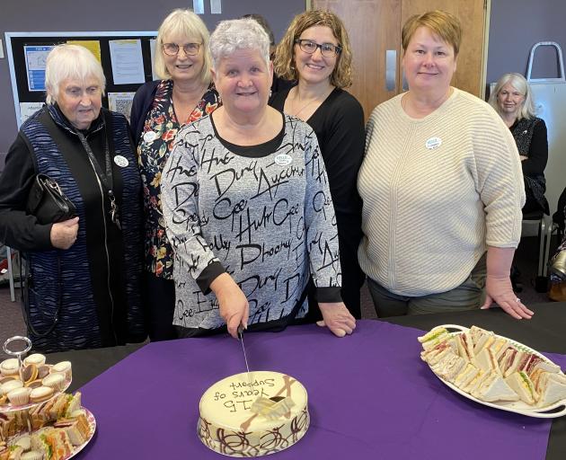 Cutting the cake to mark 15 years of the Brain Injury Otago service on Tuesday are (from left)...