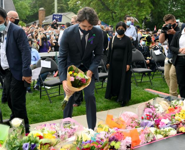 Canadian Prime Minister Justin Trudeau places flowers at a vigil outside the London Muslim Mosque...