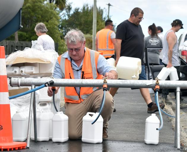 Calvin White of the DCC filling Water containers in Waikouaiti today. PHOTO:PETER MCINTOSH