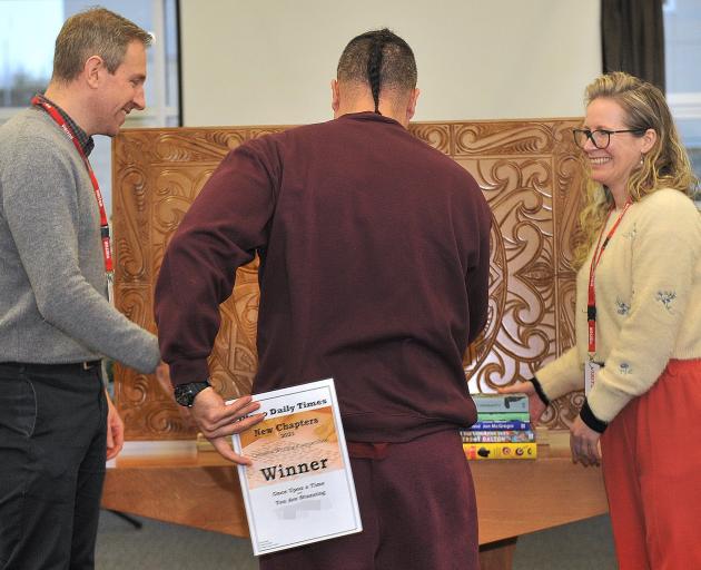 The winner of both ‘‘New Chapters’’ categories receives his prizes from judge Becky Manawatu...