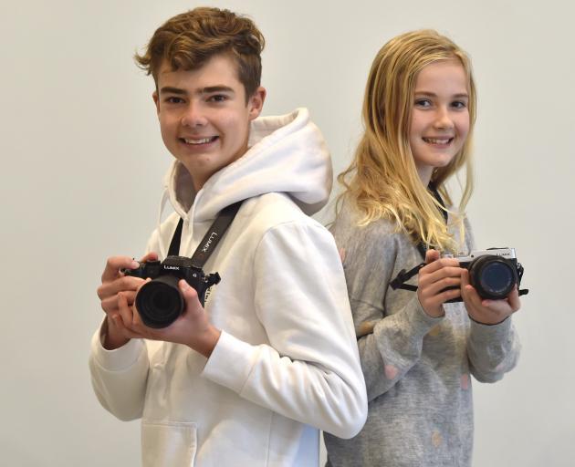 Standing back to back in the Otago Museum are award-winning photography siblings Jack and Emily...