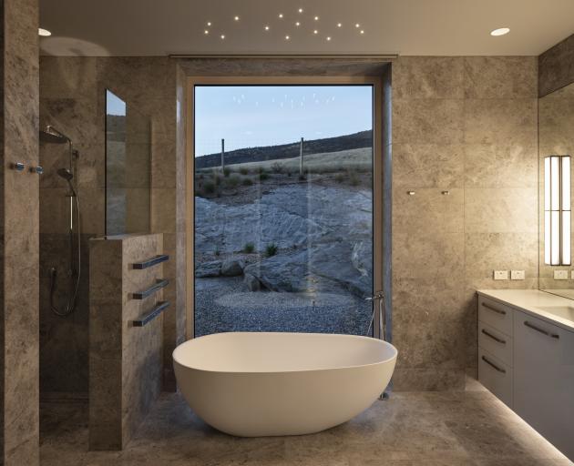 Marble and glass give the master bedroom en-suite a simple but sophisticated feel.