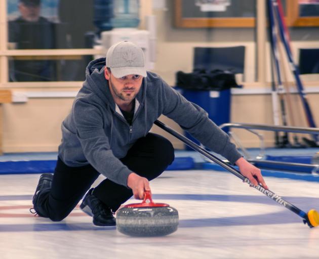 Scott Becker prepares to release his stone at the New Zealand Mixed Doubles Curling Competition...