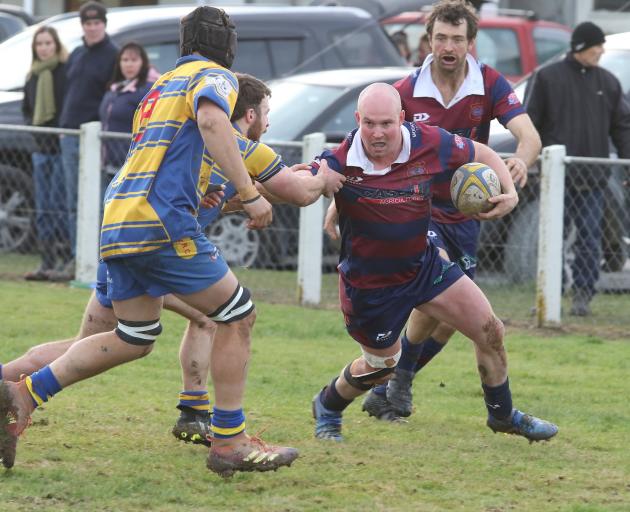 West Taieri’s Will Scorgie (with ball) makes his way through Toko’s tacklers during their...