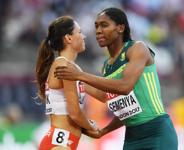 Caster Semenya, of South Africa, and Joanna Jozwik, of Poland, shake following  an 800m heat  at...