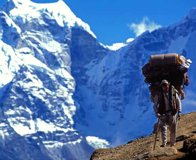 A sherpa carries bags on a Mt Everest trail. PHOTO: GETTY IMAGES
