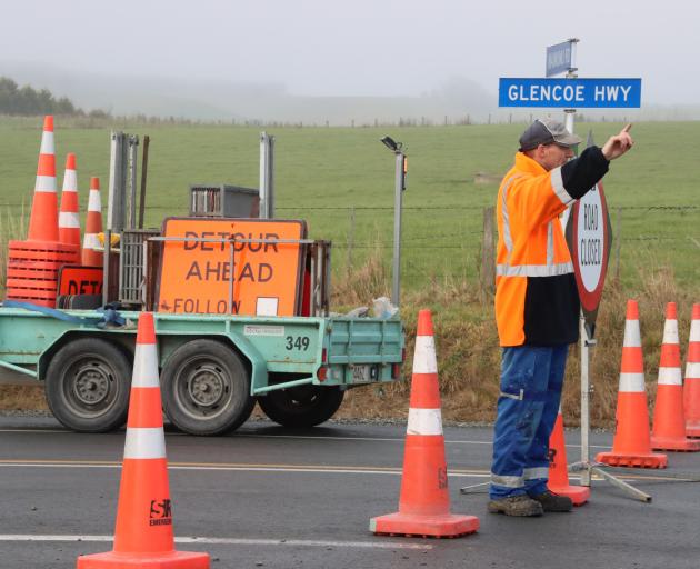 McDonough Contracting staff block off the road between Te Tipua and Mataura. Photo: Sandy Eggleston
