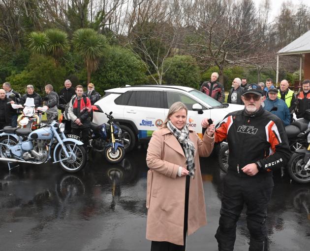 Otago Motorcycle Club Brass Monkey rally chairman Alan Dodds presents Otago Community Hospice...