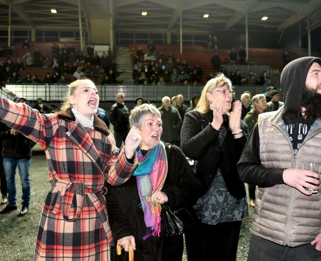 Georgina McCullough (left) urges on Livy Desma, a horse named after her aunt, in race 2 at...