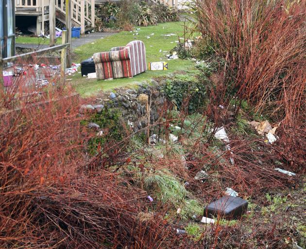 Rubbish from a Leith St student party spills down the Water of Leith bank yesterday. PHOTO:...