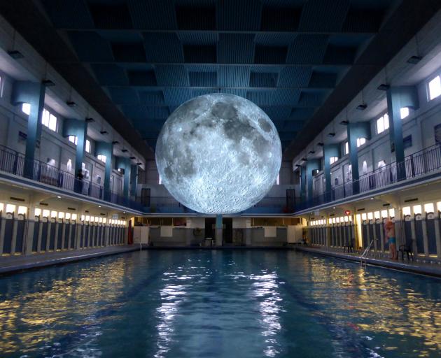 Museum of the Moon hovers over the main pool at St George’s Swimming Pool, in Rennes, France. ...