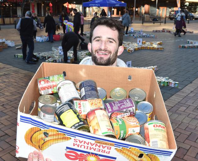 Volunteer George Blake with a selection of cans given to the appeal. Photo: Gregor Richardson