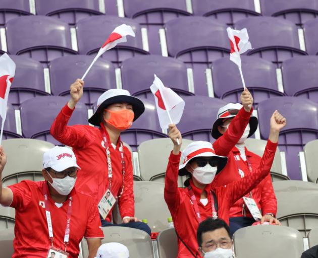 Spectators for Team Japan cheer during the Men's Team semi-finals. Photo: Getty Images