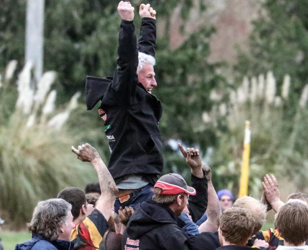 Union rugby coach Peter Stackhouse is hoisted aloft by players and supporters after the North...