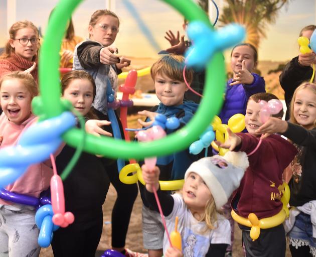 Children shoot balloon mice through a hoop while learning about kinetic energy at the Golden...