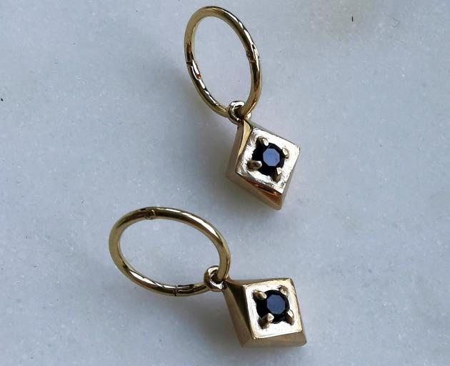 Set Diamond Hoops are made of sterling silver, plated in gold and set with black spinel. These...