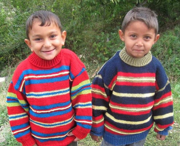 A pair of Romanian children wear warm woollen jumpers donated through Operation Cover Up. PHOTO:...