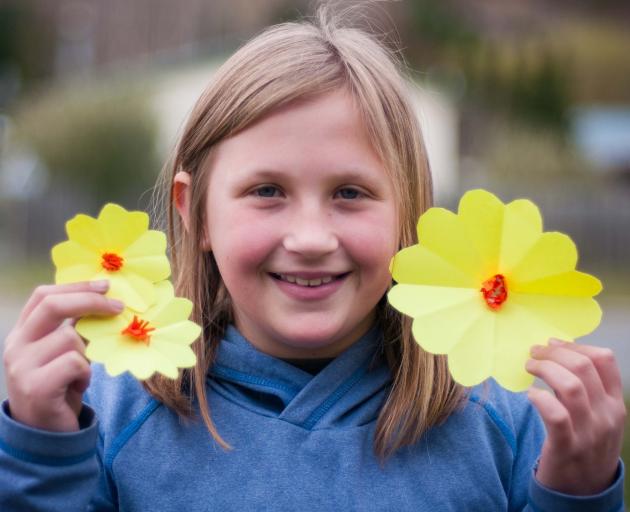 Jody Velenski (10) shows off her handiwork to raise money for the Cancer Society’s Daffodil Day...