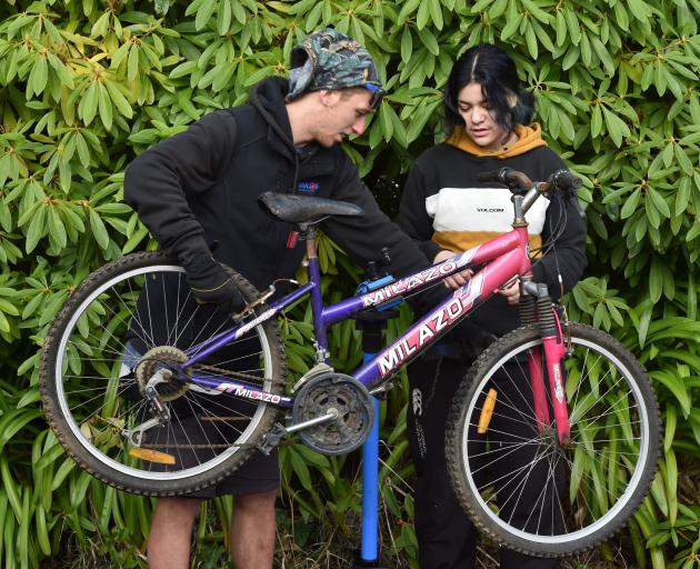Alex Gorrie and Lilly Hamilton (16) work on a bike at the Malcam Trust this week. PHOTO: GREGOR...