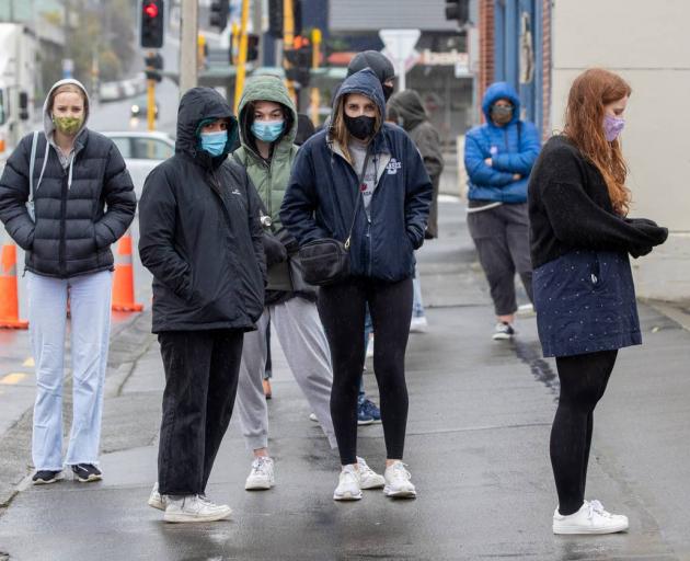 People wearing masks waiting to be tested for Covid-19 at the Taranaki St site in Wellington....