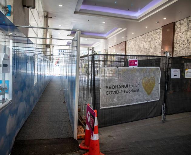 A public walkway is separated from the Crowne Plaza MIQ facility by a screen. Photo: NZ Herald