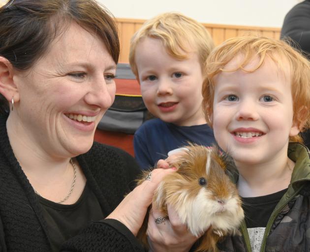 Alex Ferguson, of Dunedin, and her two sons Max (3, left)  and Ollie (5), cuddle long-haired...