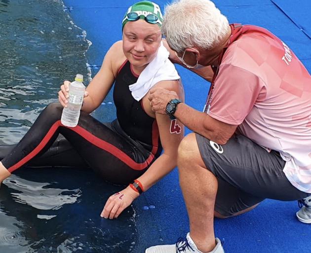 Dave Gerrard, working as a medical commissioner, comforts South African competitor Michelle...