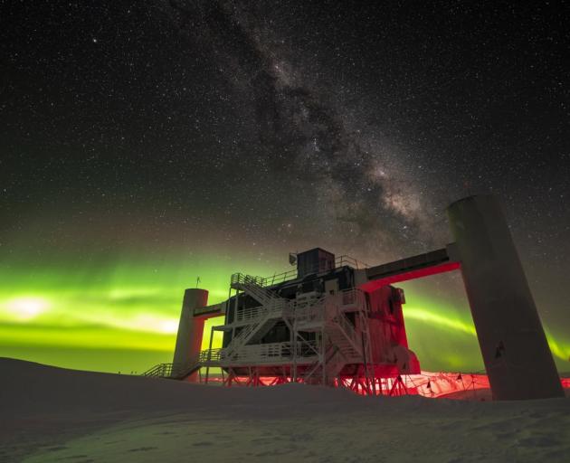 The IceCube observatory at the South Pole with the Aurora Australis (The Southern Lights) in the...