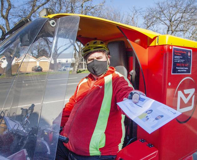Postie Nick Shaw hard at work on Bealey Ave.