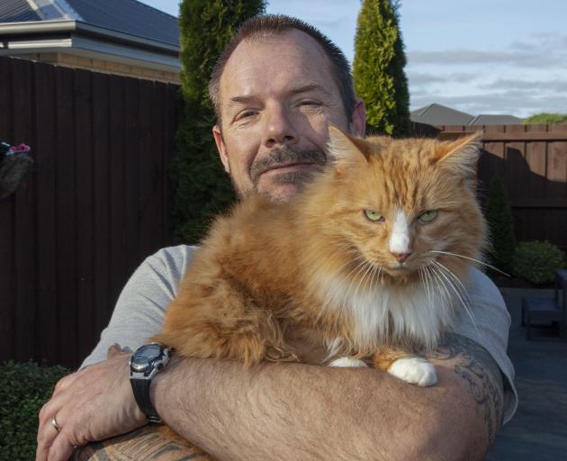 Dean Rockhouse and his cat Lucky. Photo: Geoff Sloan