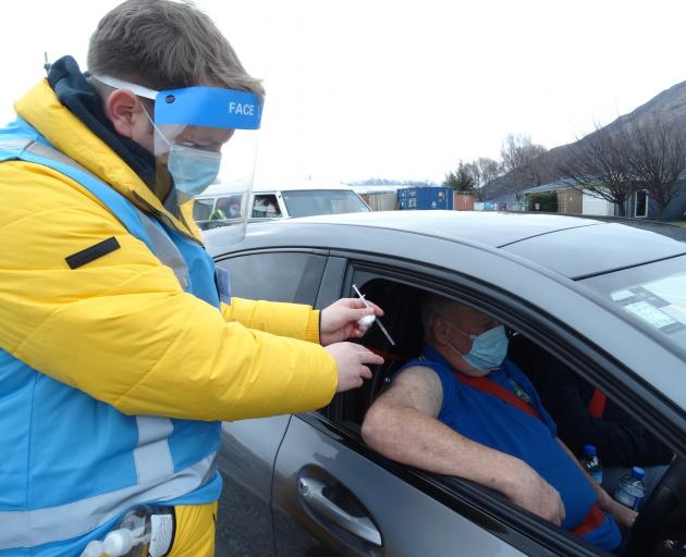 Evan Johnston, of Kingston, gets a Covid-19 vaccination from Brendon McIntosh at the Queenstown...