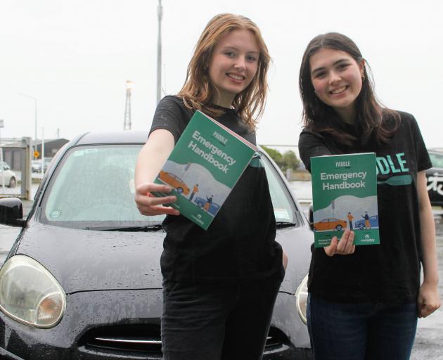 Eden Selman and Stellar Waipouri (both 17) show the guide they created to help teenagers facing...