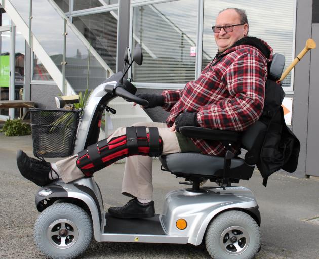 Trevor Hitchman, of South Dunedin, shows the mobility scooter he was able to buy thanks to a low...