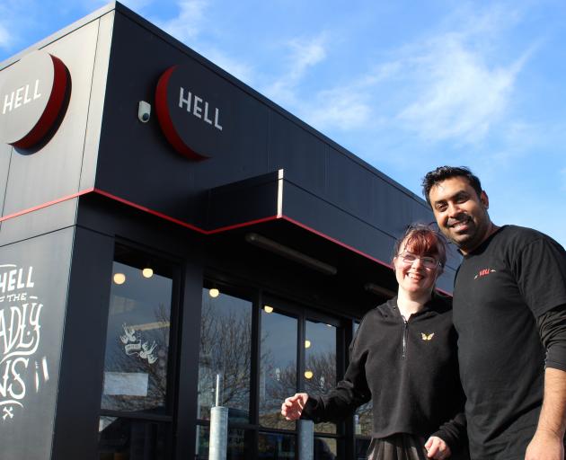 Chloe Simonsen greets Hell Pizza South Dunedin franchise owner Hamish Dua outside the store.PHOTO...