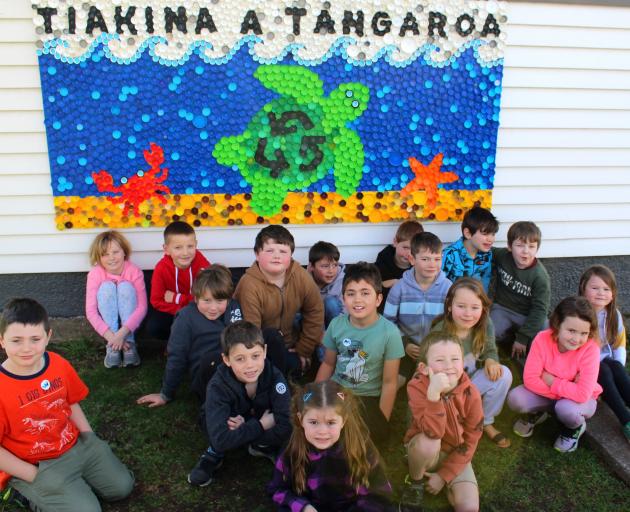 Sawyers Bay School year two and three pupils show a mural created from recycled bottle caps at...