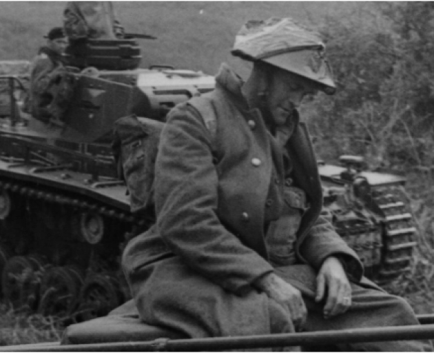 An unknown Kiwi soldier sits at the back of a German tank after being captured in 1941. Photo:...