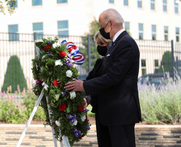 US President Joe Biden and first lady Jill Biden lay a wreath at the Pentagon, also a site of the...