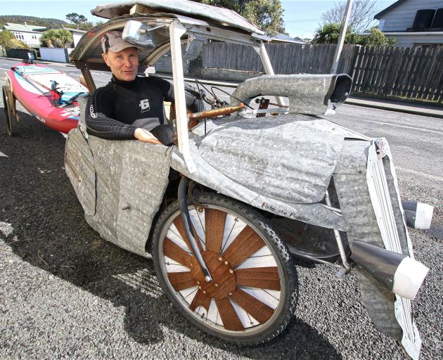 Kaka Point stand›up paddleboarder and corrugated iron sculptor Tony Somerville with the home›built pedal car he uses to transport his 3m paddleboard down the beach. PHOTO: JOHN COSGROVE