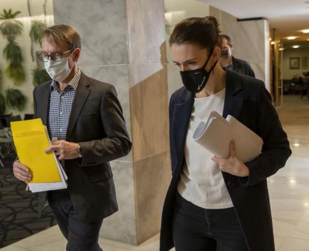 A masked-up Ashley Bloomfield with Prime Minister Jacinda Ardern. Photo: Pool / NZME