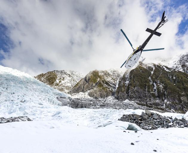 Helicopter leaving Franz Josef Glacier. Photo: Getty Images