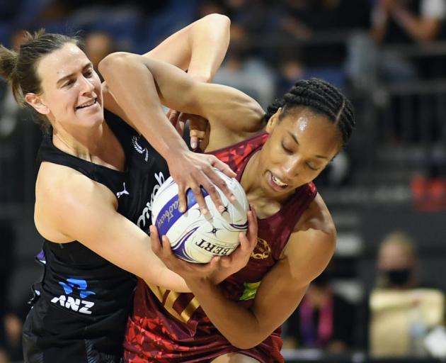 Silver Fern Claire Kersten tries to wrestle the ball from England's Layla Guscoth. Photo: Getty...