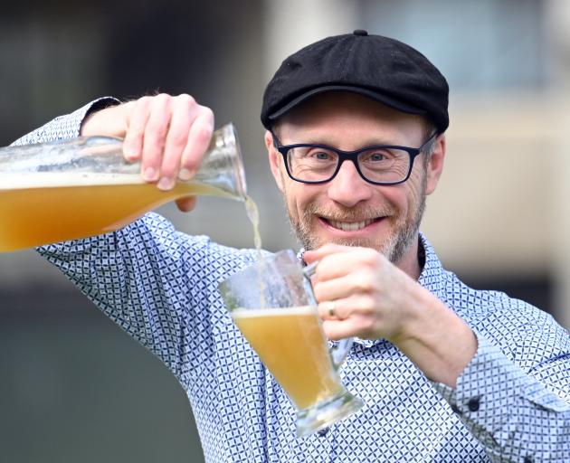 Pouring a fresh glass of upcycled ginger beer, brewed using old bread and damaged fruit, is...